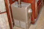 Photo shows original gas heater in 1937 Royal Wilheim Trailer living room